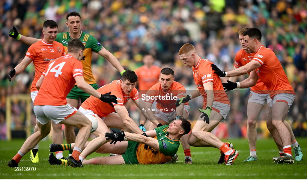 12 May 2024; Ciaran Thompson of Donegal passes under pressure from Armagh players during the Ulster GAA Football Senior Championship final match between Armagh and Donegal at St Tiernach's Park in Clones, Monaghan. Photo by Ramsey Cardy/Sportsfile
