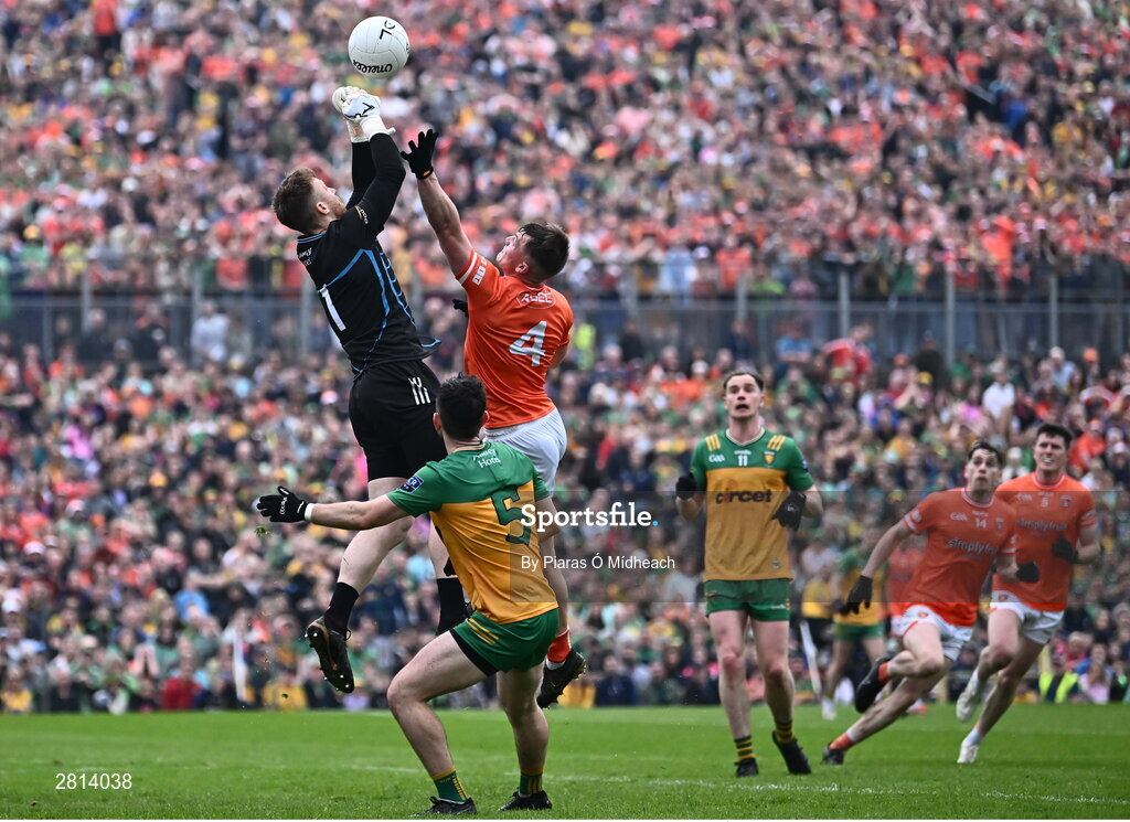 12 May 2024; Donegal goalkeeper Shaun Patton, supported by team-mate Ryan McHugh, in action against Peter McGrane of Armagh during the Ulster GAA Football Senior Championship final match between Armagh and Donegal at St Tiernach's Park in Clones, Monaghan. Photo by Piaras Ó Mídheach/Sportsfile