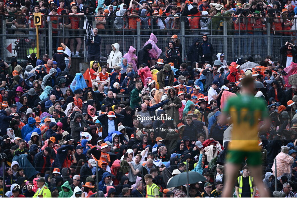 12 May 2024; Spectators during a rain shower in the Ulster GAA Football Senior Championship final match between Armagh and Donegal at St Tiernach's Park in Clones, Monaghan. Photo by Piaras Ó Mídheach/Sportsfile