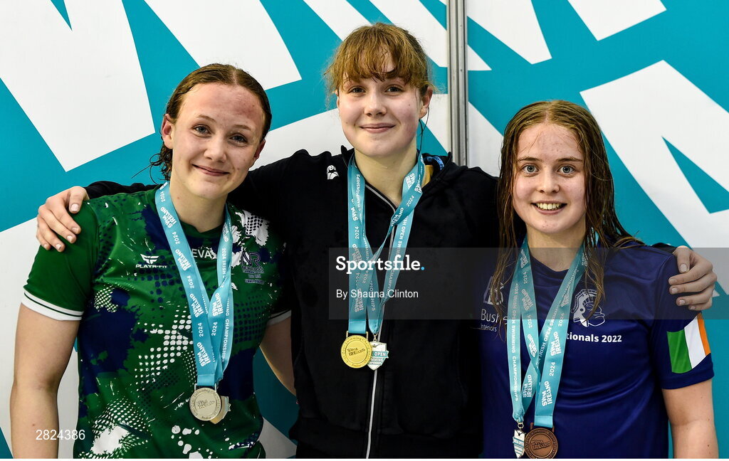 23 May 2024; Alana Burns-Atkin of Banbridge, centre, who won gold, with Eva Bayley of New Ross Swimming Club, left, who won silver, and Hannah Poynton of Trojan Swimming Club, who won bronze, after competing in the Women's 200m Butterfly Super Final during day two of the Ireland Olympic Swimming Trials at the National Aquatic Centre on the Sport Ireland Campus in Dublin. Photo by Shauna Clinton/Sportsfile