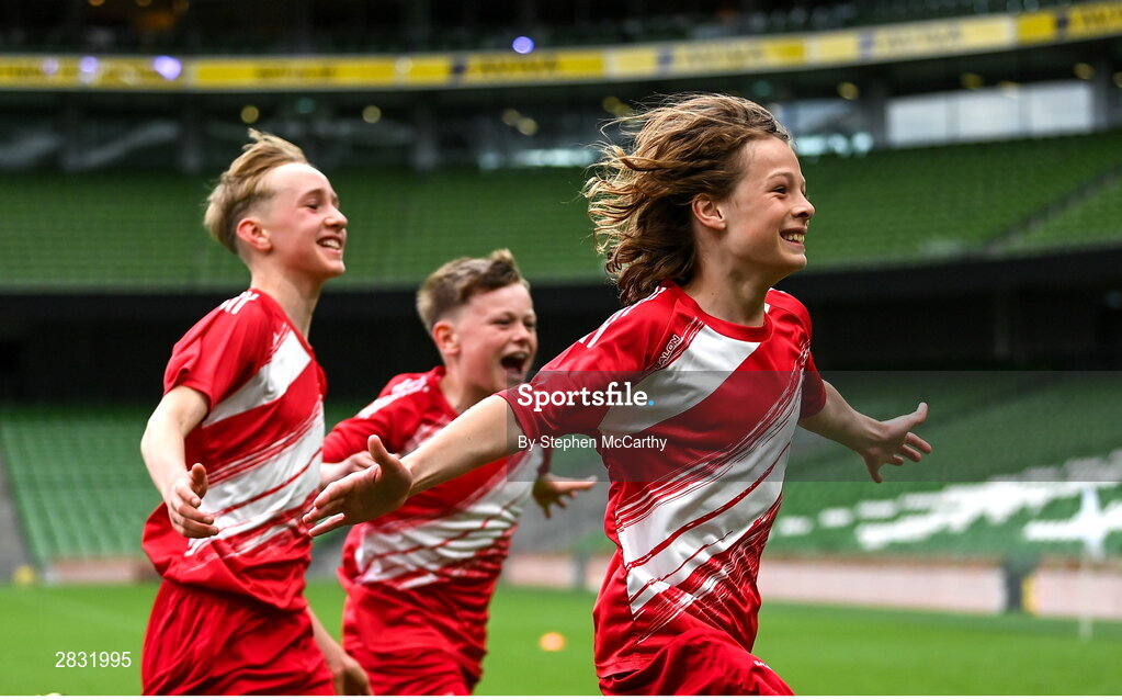 29 May 2024; Fionn O’Leary and his Beaumont BNS, Blackrock, Cork, team-mates celebrates after winning the A cup, for mixed small sized schools, during the FAI Primary 5s Finals day at Aviva Stadium in Dublin. Photo by Stephen McCarthy/Sportsfile