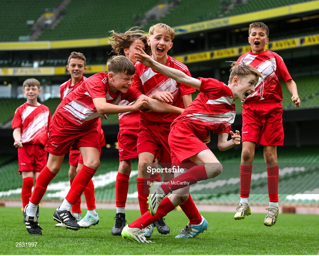 29 May 2024; Kieran Stack and his Beaumont BNS, Blackrock, Cork, team-mates celebrate after winning the C Cup, for mixed large sized schools, following a penalty shoot-out in their play-off match during the FAI Primary 5s Finals day at Aviva Stadium in Dublin. Photo by Stephen McCarthy/Sportsfile
