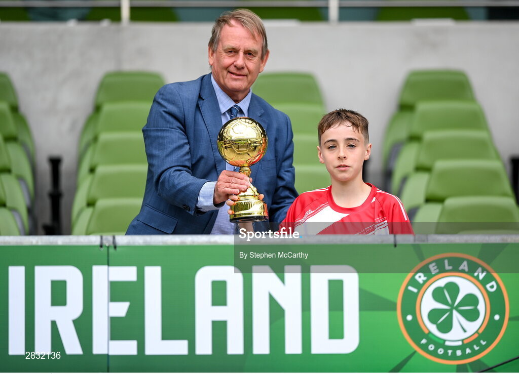 29 May 2024; Tom Ó Caoimh of Gaelscoil Choinn tSáile, Cork, is presented with the section B, for mixed medium sized schools, player of the tournament award by FAI board member Nixon Morton during the FAI Primary 5s Finals day at Aviva Stadium in Dublin. Photo by Stephen McCarthy/Sportsfile