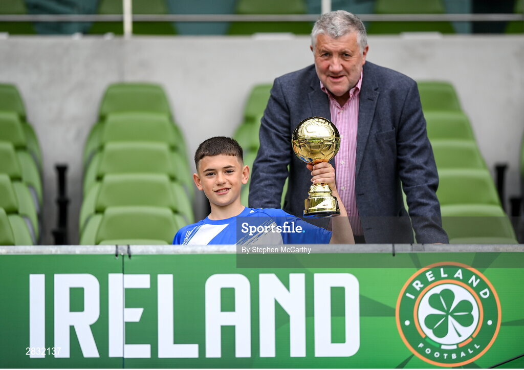29 May 2024; Patrick Toth of St Declan’s NS, Ashbourne, Meath, is presented with the section C, for mixed large sized schools, player of the tournament award by FAI president Paul Cooke during the FAI Primary 5s Finals day at Aviva Stadium in Dublin. Photo by Stephen McCarthy/Sportsfile