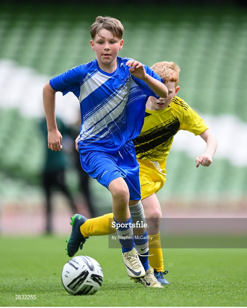 29 May 2024; Lennon O’Brien of Scoil Eoin, Crumlin, Dublin, in action against Eoin Hirrell of Scoil Íosagáin, Buncrana, Inishowen, Donegal, during the FAI Primary 5s Finals day at Aviva Stadium in Dublin. Photo by Stephen McCarthy/Sportsfile