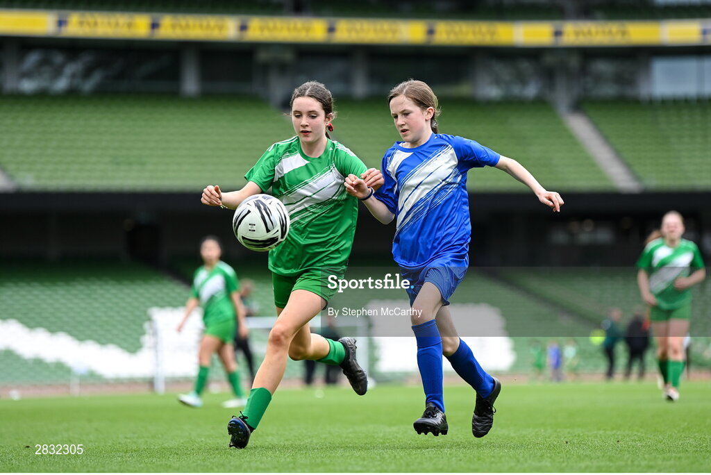 29 May 2024; Nicole Cummins of Tierneevin NS, Galway, left, in action against Keira Lyons of St Leonard’s NS, Dunnamaggin, Kilkenny, in their girls section A cup, for small sized schools, match during the FAI Primary 5s Finals day at Aviva Stadium in Dublin. Photo by Stephen McCarthy/Sportsfile