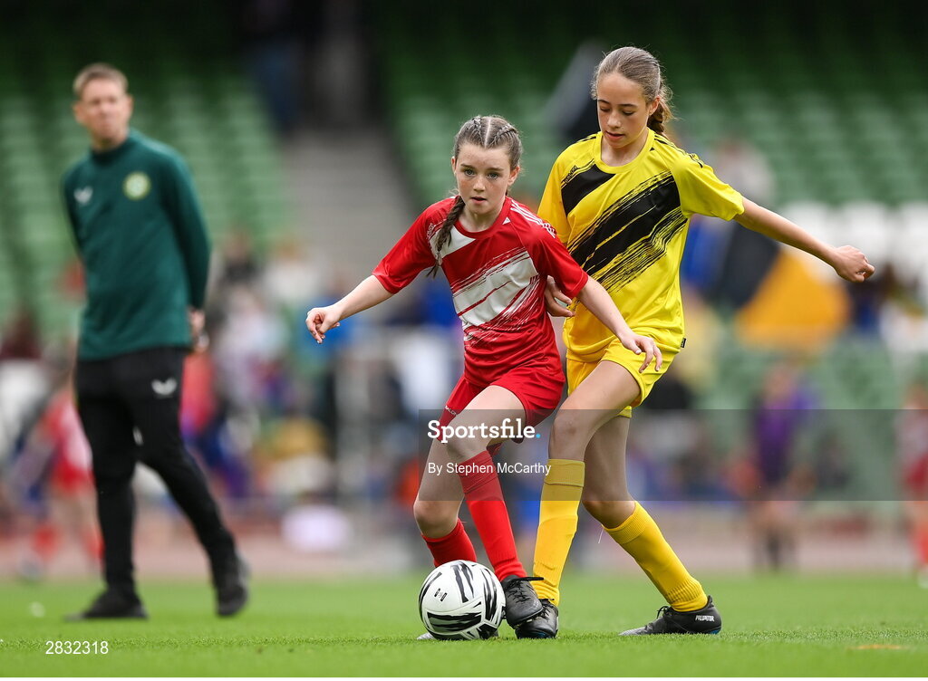 29 May 2024; Roise Walsh of Gurrane NS, Cork, in action against Riona Crowe of Scoil Mhuire, Lacken, Cavan, right, during the FAI Primary 5s Finals day at Aviva Stadium in Dublin. Photo by Stephen McCarthy/Sportsfile