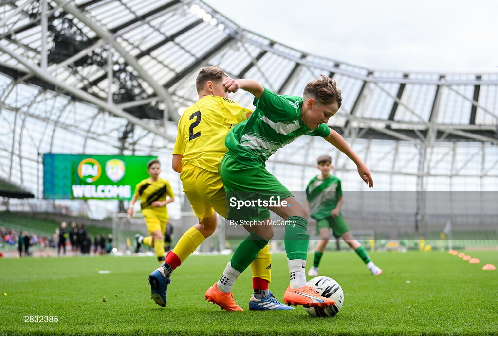 29 May 2024; Fionn Jennings of St Joseph’s PS, Ballinrobe, Mayo, in action against Ryan Gallagher of Illistrin NS, Donegal, left, during the FAI Primary 5s Finals day at Aviva Stadium in Dublin. Photo by Stephen McCarthy/Sportsfile