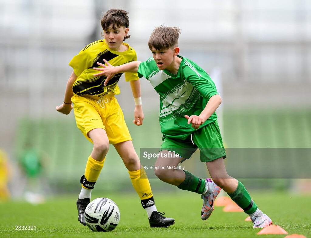 29 May 2024; Matthew Tierney of St Joseph’s PS, Ballinrobe, Mayo, in action against Diarmuid McFadden of Illistrin NS, Donegal, left, during the FAI Primary 5s Finals day at Aviva Stadium in Dublin. Photo by Stephen McCarthy/Sportsfile