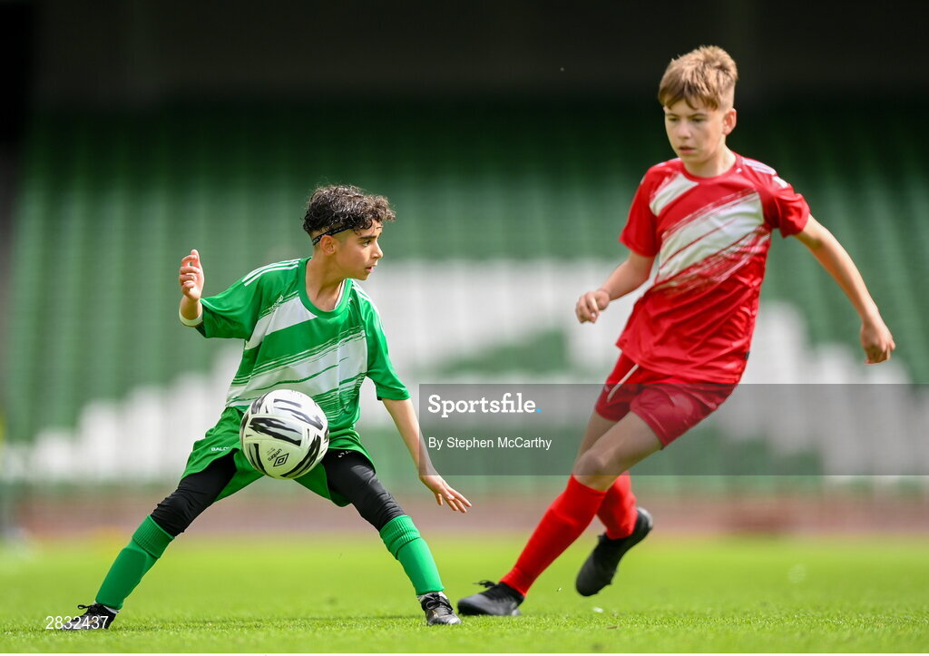 29 May 2024; Mounir Soufan of Scoil Phádraig, Westport, Mayo, in action against Noah Ó Laoi of Gaelscoil Choinn tSáile, Cork, right, during the FAI Primary 5s Finals day at Aviva Stadium in Dublin. Photo by Stephen McCarthy/Sportsfile