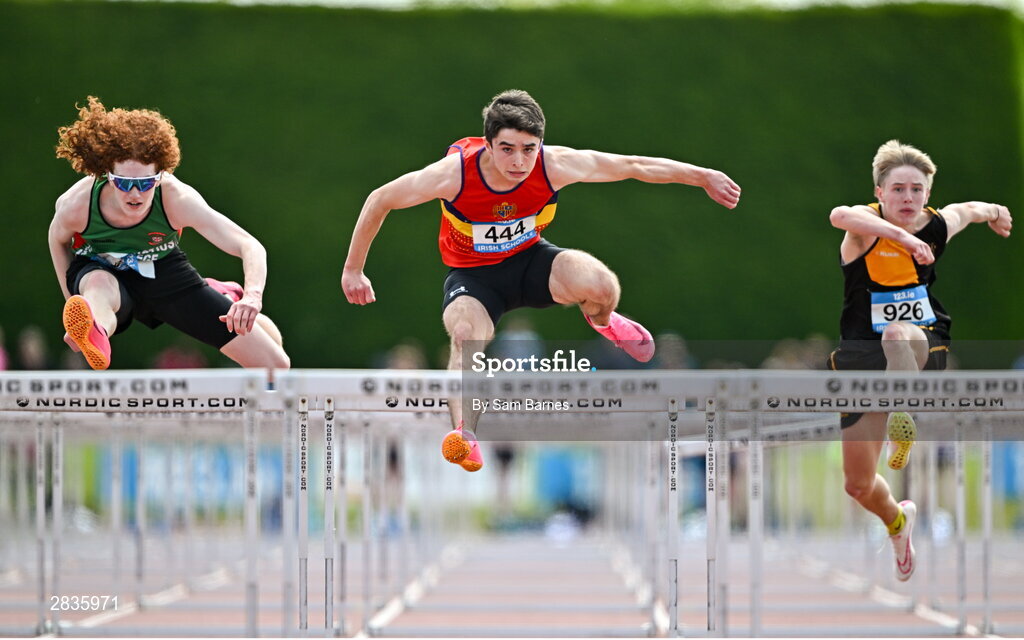 1 June 2024; Des O'Neill of St. Fintans, on his way to winning the inter boys 100m hurdles, ahead of Conor Penney of Calasanctius College Oranmore, Galway, left, and Cameron  McCracken of Royal Belfast Academy, right, during day two of the 123.ie All-Ireland Schools’ Track and Field Championships at Tullamore Harriers Athletics Club in Offaly. Photo by Sam Barnes/Sportsfile