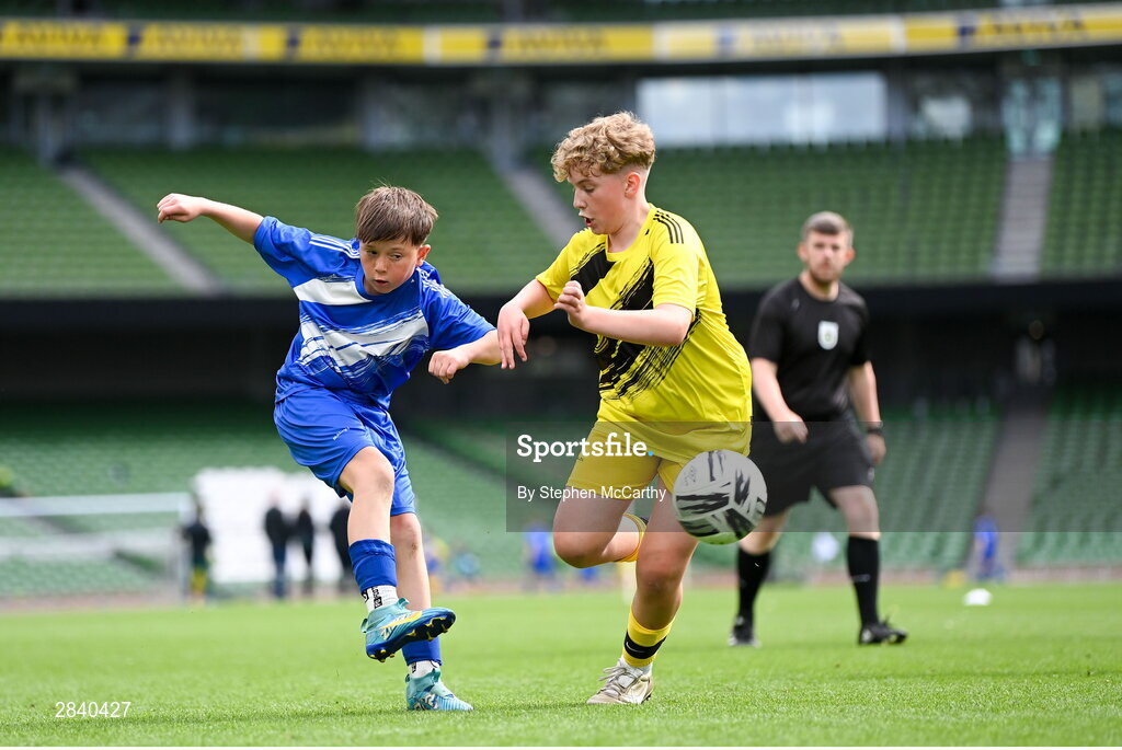 29 May 2024; Oisín Melia of Kentstown NS, Meath, scores a goal despite the attention of Riley McBride of St Eunan’s NS, Raphoe, Donegal, during the FAI Primary 5s Finals day at Aviva Stadium in Dublin. Photo by Stephen McCarthy/Sportsfile