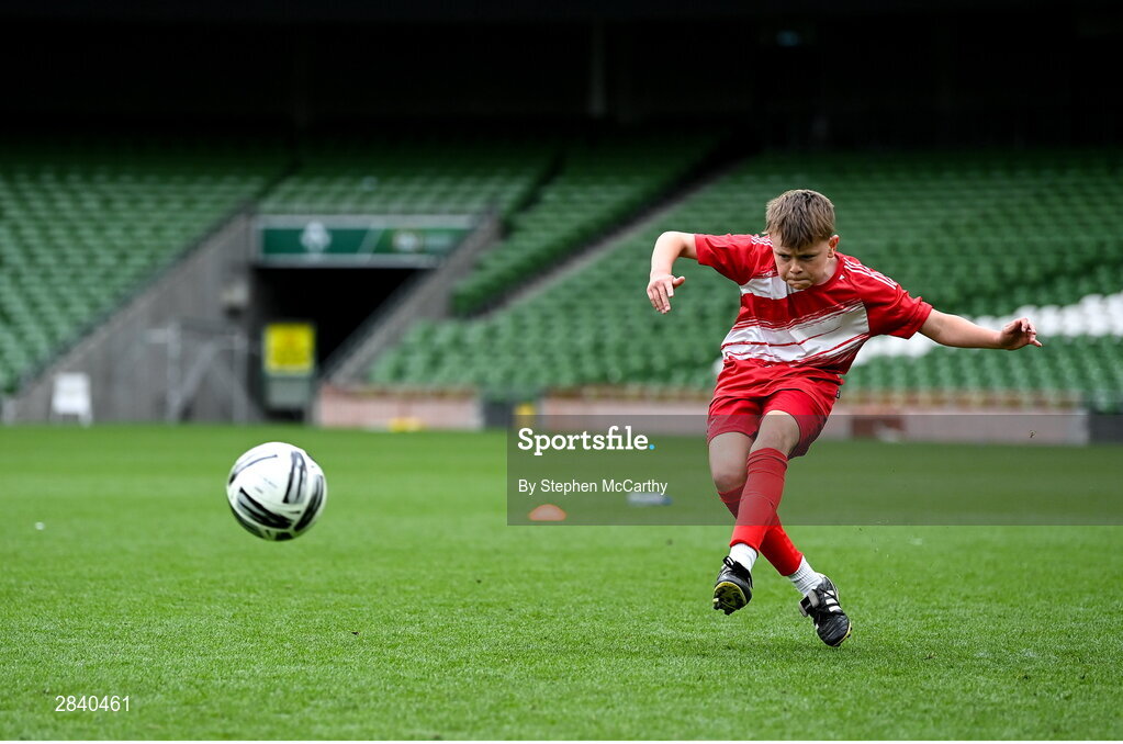 29 May 2024; Conor Browne of Beaumont BNS, Blackrock, Cork, scores a penalty in a shoot-out for the section C cup, for mixed large sized schools, during the FAI Primary 5s Finals day at Aviva Stadium in Dublin. Photo by Stephen McCarthy/Sportsfile