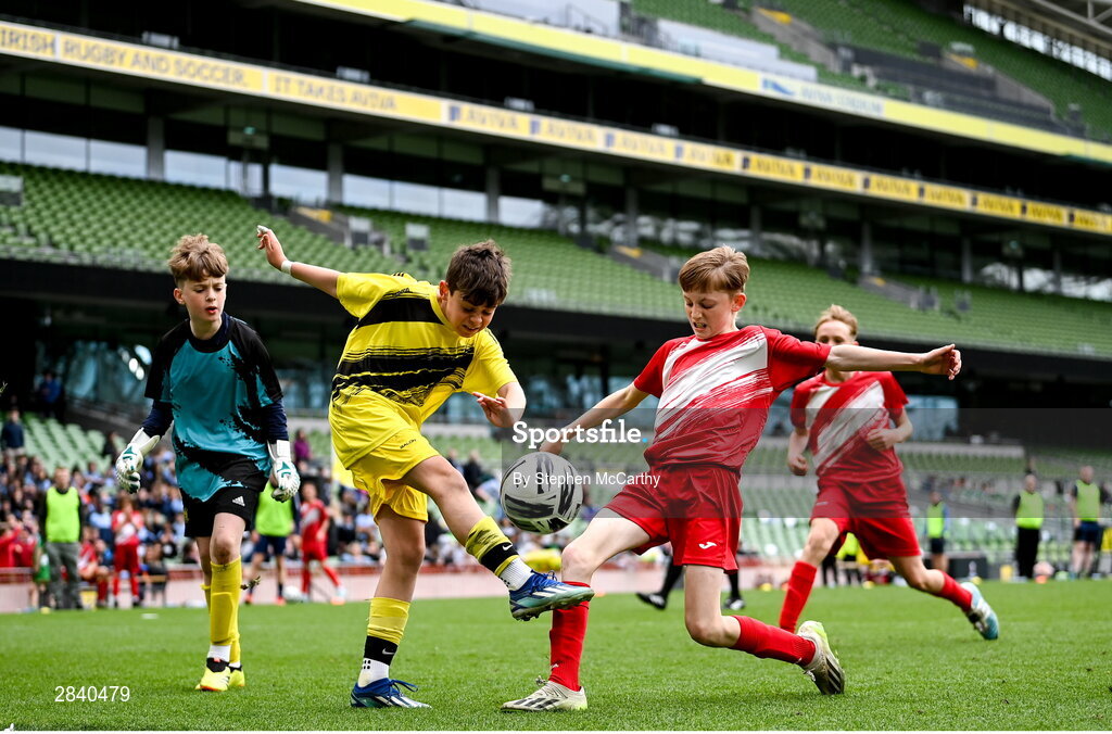 29 May 2024; Oisin Cuskelly of Illistrin NS, Donegal, yellow, and Kieran Stack of Beaumont BNS, Blackrock, Cork, during the FAI Primary 5s Finals day at Aviva Stadium in Dublin. Photo by Stephen McCarthy/Sportsfile