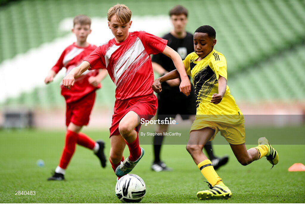 29 May 2024; Sam Bruton of Beaumont BNS, Blackrock, Cork, and Amini Twalib of Illistrin NS, Donegal, right, during the FAI Primary 5s Finals day at Aviva Stadium in Dublin. Photo by Stephen McCarthy/Sportsfile