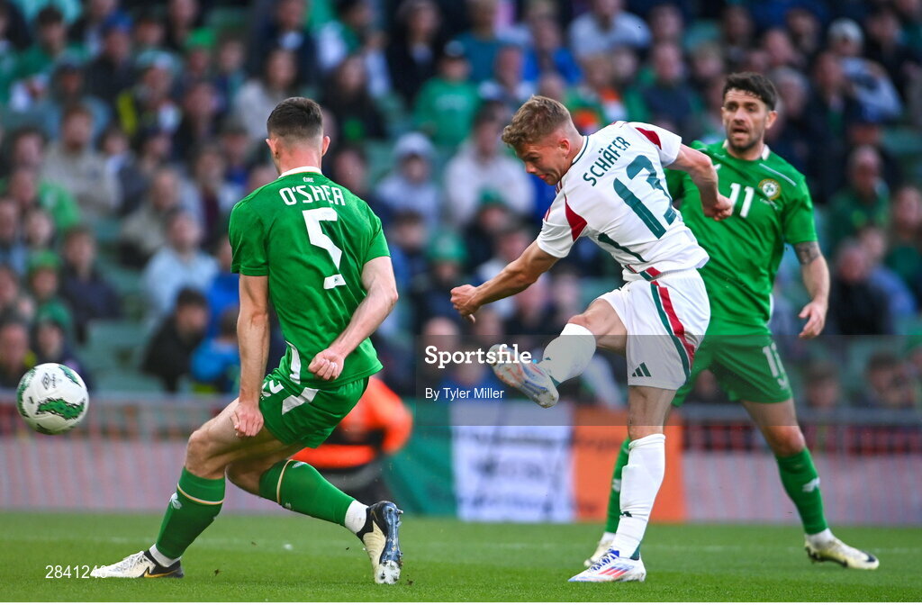 4 June 2024; András Schäfer of Hungary has a shot on goal under pressure from Dara O'Shea and Robbie Brady of Republic of Ireland during the international friendly match between Republic of Ireland and Hungary at Aviva Stadium in Dublin. Photo by Tyler Miller/Sportsfile