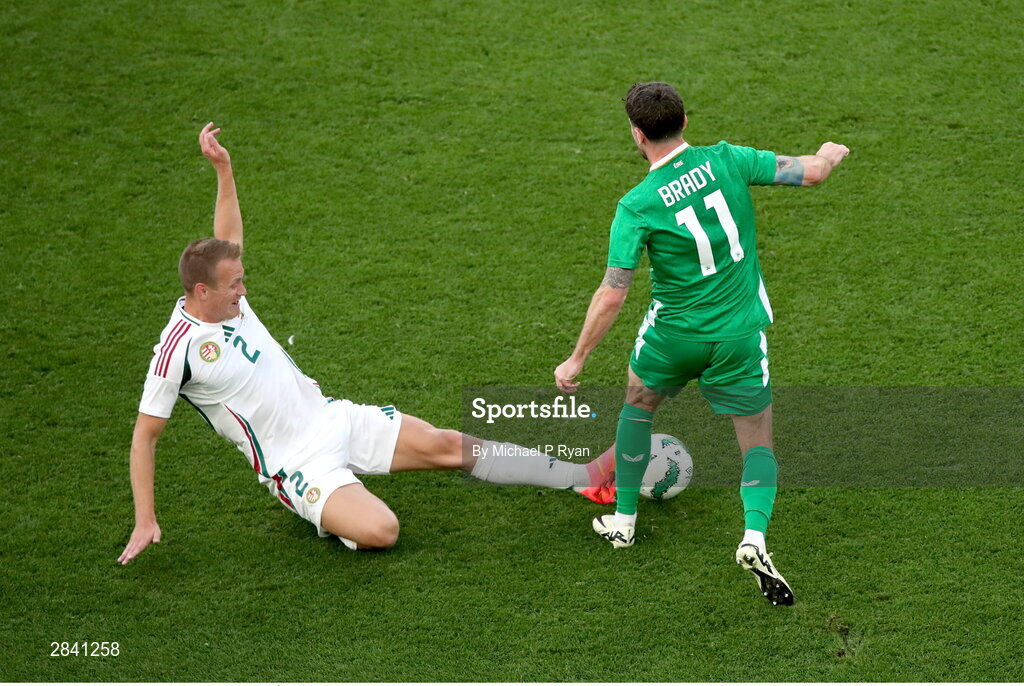 4 June 2024; Robbie Brady of Republic of Ireland in action against Ádám Lang of Hungary during the international friendly match between Republic of Ireland and Hungary at Aviva Stadium in Dublin. Photo by Michael P Ryan/Sportsfile