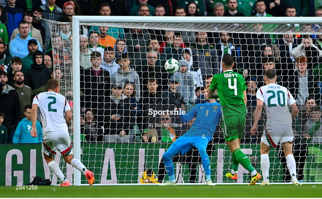 4 June 2024; Ádám Lang of Hungary, 2, shoots to score his side's first goal past Republic of Ireland goalkeeper Caoimhin Kelleher during the international friendly match between Republic of Ireland and Hungary at Aviva Stadium in Dublin. Photo by Ben McShane/Sportsfile