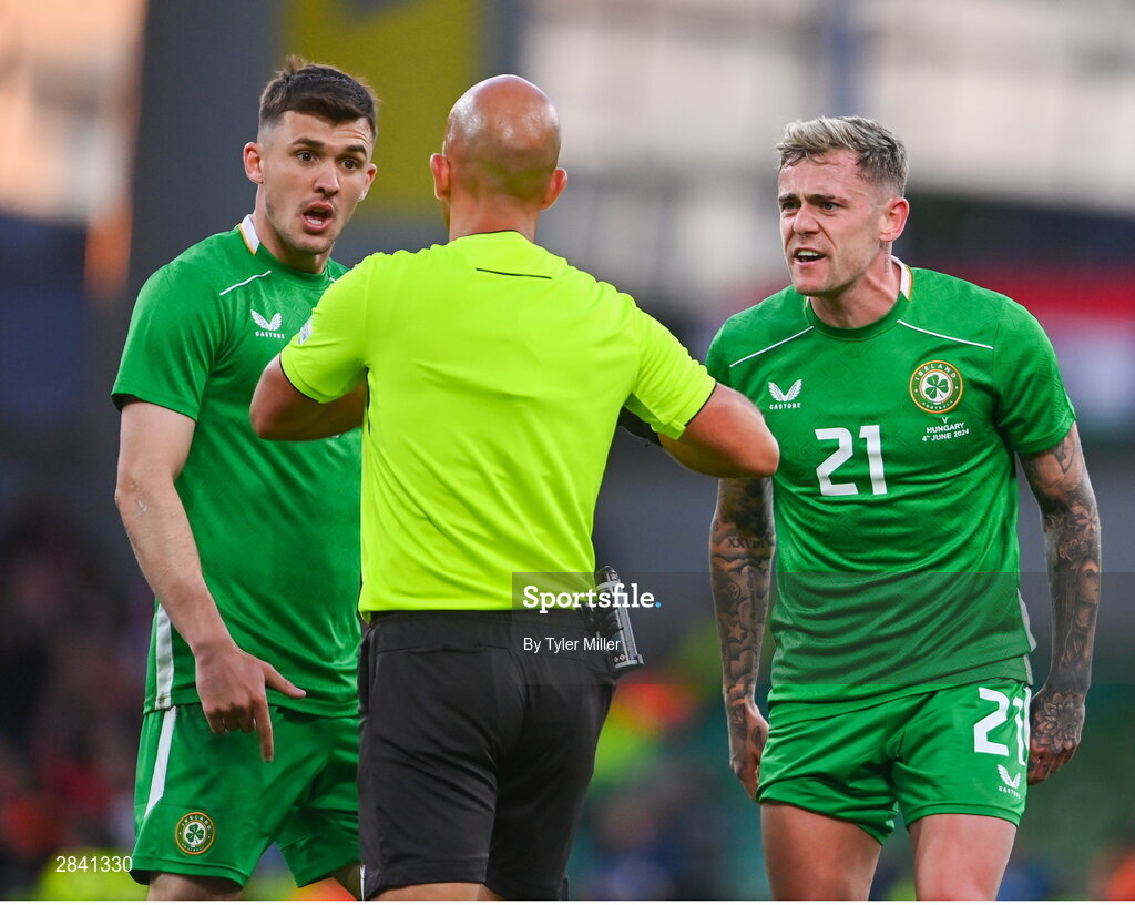 4 June 2024; Jason Knight and Sammie Szmodics of Republic of Ireland remostrate with referee Luis Godinho during the international friendly match between Republic of Ireland and Hungary at Aviva Stadium in Dublin. Photo by Tyler Miller/Sportsfile