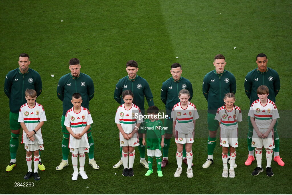 4 June 2024; Republic of Ireland players, from left, Shane Duffy, Matt Doherty, Robbie Brady, Josh Cullen, Dara O'Shea, and Adam Idah, with mascots before the international friendly match between Republic of Ireland and Hungary at Aviva Stadium in Dublin. Photo by Michael P Ryan/Sportsfile