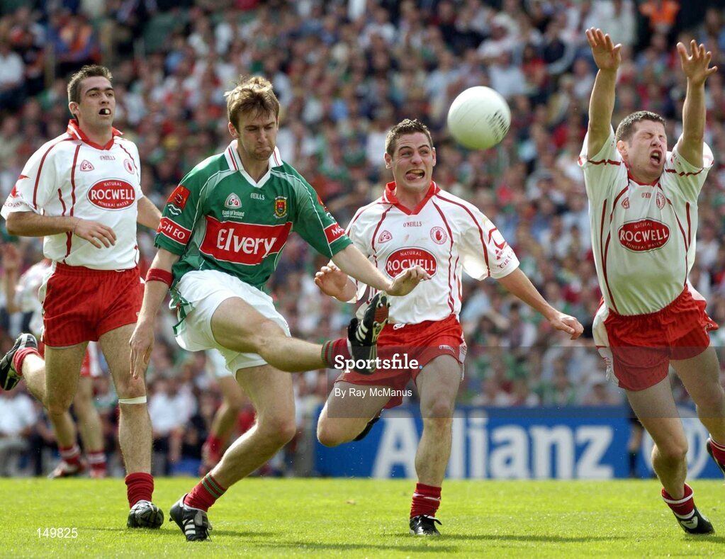 7 August 2004; Ronan McGarrity, Mayo, shots and scores a point despite the attentions of Sean Cavanagh and Michael McGee, Tyrone. Bank of Ireland All-Ireland Senior Football Championship Quarter Final, Mayo v Tyrone, Croke Park, Dublin. Picture credit; Ray McManus / SPORTSFILE