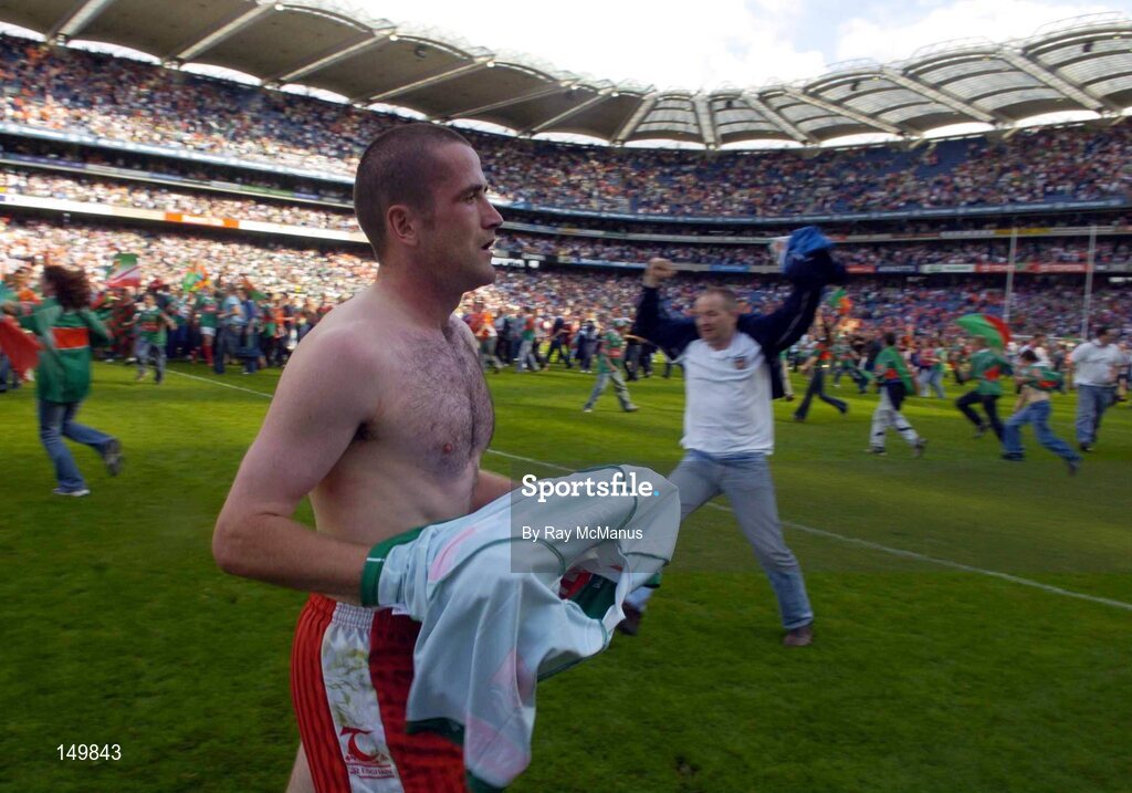 7 August 2004; A dejected Stephen O'Neill, Tyrone, leaves the field as Mayo supporters celebrate their sides victory. Bank of Ireland All-Ireland Senior Football Championship Quarter Final, Mayo v Tyrone, Croke Park, Dublin. Picture credit; Ray McManus / SPORTSFILE