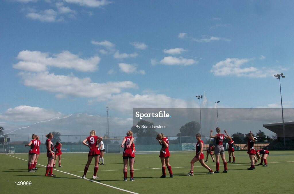 30 July 2004; The Belarus team warm up as the pitch is watered. European Hockey Junior Championship, Cross Over Match, Ireland v Belarus, UCD, Belfield, Dublin. Picture credit; Brian Lawless / SPORTSFILE
