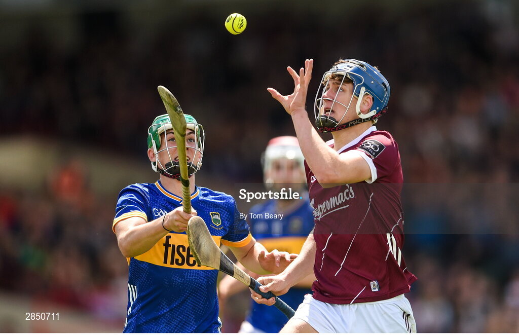 15 June 2024; Ciarán Leen of Galway in action against David Ryan of Tipperary during the Electric Ireland GAA Hurling All-Ireland Minor Hurling Championship semi-final match between Tipperary and Galway at TUS Gaelic Grounds in Limerick. Photo by Tom Beary/Sportsfile