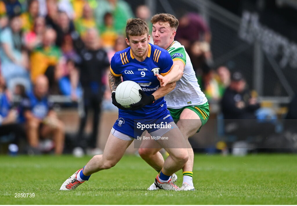 15 June 2024; Michéal Garry of Clare is tackled by Odhran Doherty of Donegal during the GAA Football All-Ireland Senior Championship Round 3 match between Clare and Donegal at Hastings Insurance MacHale Park in Castlebar, Mayo. Photo by Ben McShane/Sportsfile