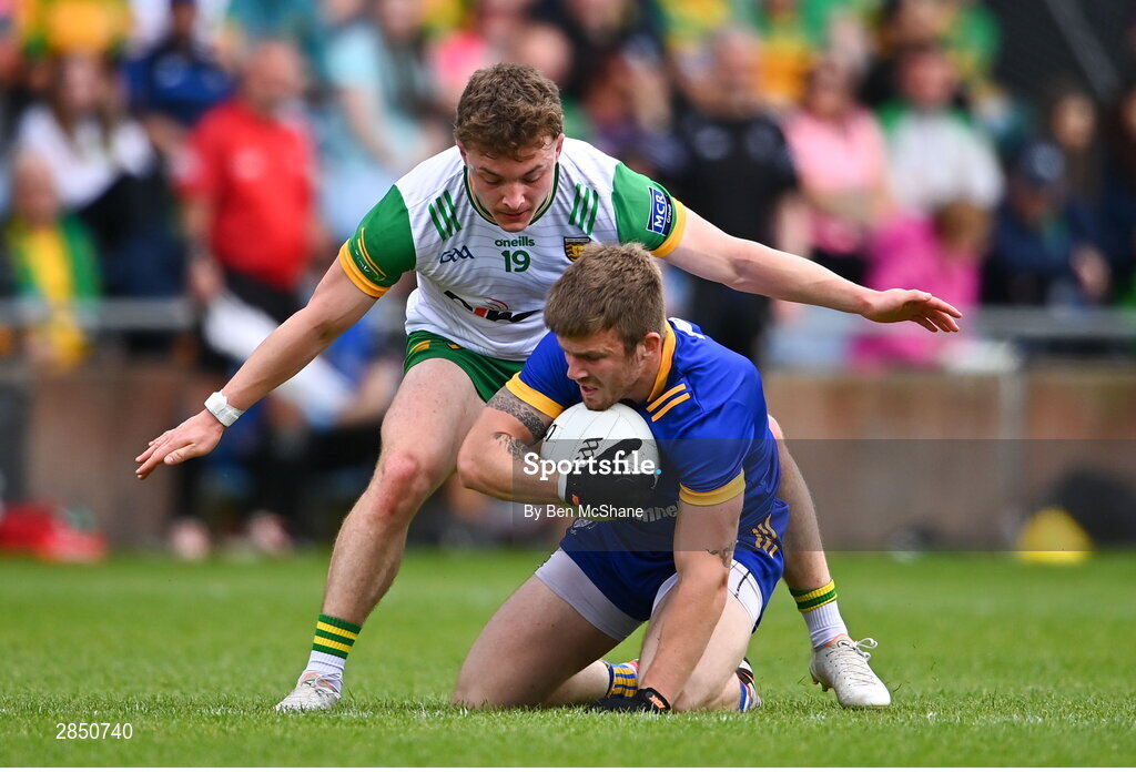 15 June 2024; Michéal Garry of Clare is tackled by Odhran Doherty of Donegal during the GAA Football All-Ireland Senior Championship Round 3 match between Clare and Donegal at Hastings Insurance MacHale Park in Castlebar, Mayo. Photo by Ben McShane/Sportsfile