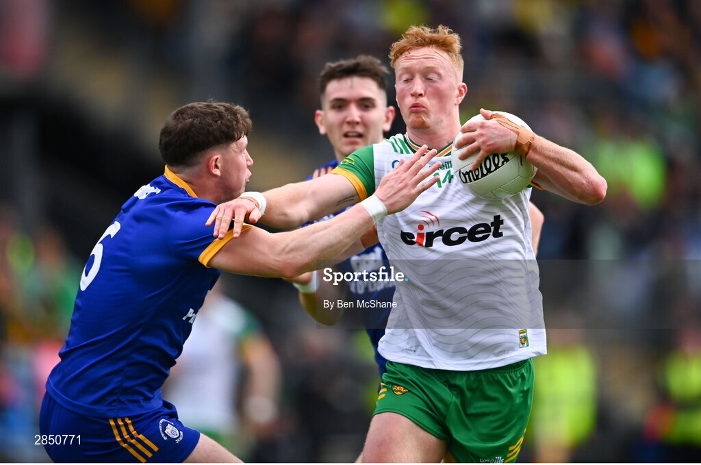 15 June 2024; Oisin Gallen of Donegal is tackled by Cillian Rouine of Clare during the GAA Football All-Ireland Senior Championship Round 3 match between Clare and Donegal at Hastings Insurance MacHale Park in Castlebar, Mayo. Photo by Ben McShane/Sportsfile