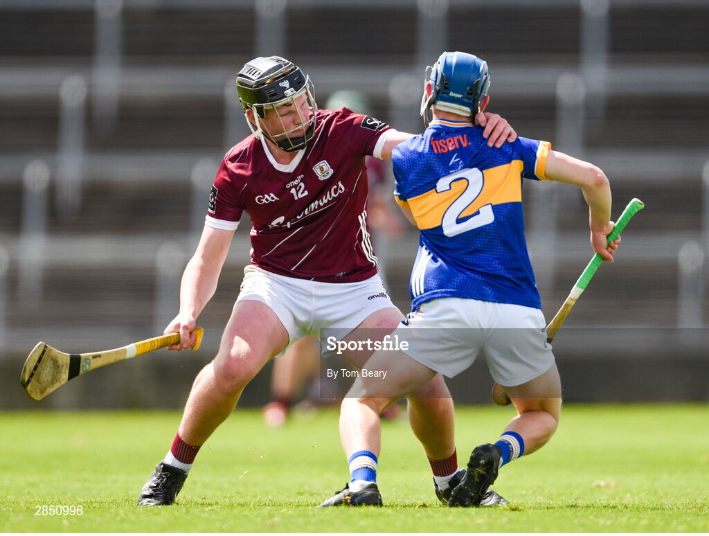 15 June 2024; Shane Ryan of Tipperary is tackled by Cillian Roche of Galway during the Electric Ireland GAA Hurling All-Ireland Minor Hurling Championship semi-final match between Tipperary and Galway at TUS Gaelic Grounds in Limerick. Photo by Tom Beary/Sportsfile