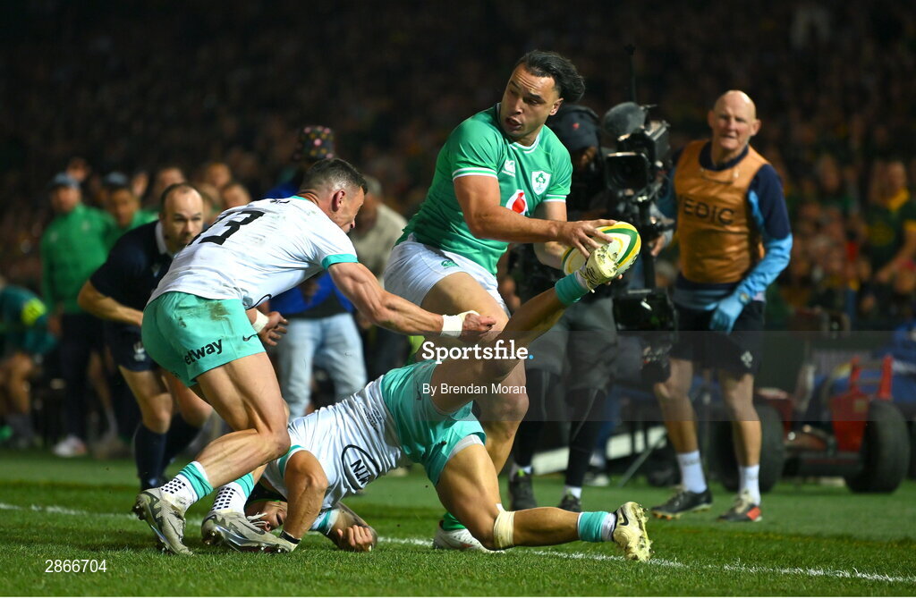 6 July 2024; James Lowe of Ireland beats the tackles of and Jesse Kriel and Cheslin Kolbe of South Africa, in the lead up to Ireland's first try, during the first test between South Africa and Ireland at Loftus Versfeld Stadium in Pretoria, South Africa. Photo by Brendan Moran/Sportsfile