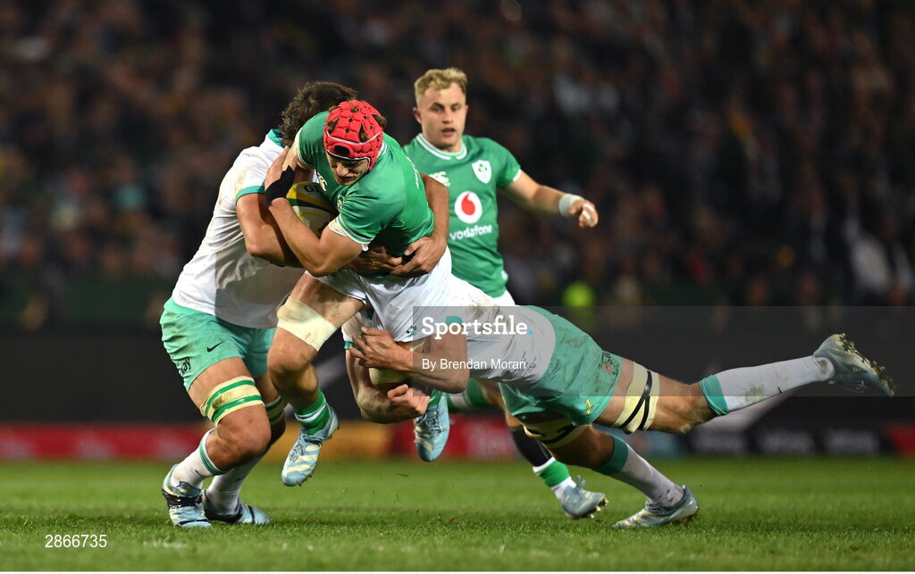 6 July 2024; Josh van der Flier of Ireland is tackled by Eben Etzebeth and Pieter-Steph du Toit of South Africa during the first test between South Africa and Ireland at Loftus Versfeld Stadium in Pretoria, South Africa. Photo by Brendan Moran/Sportsfile