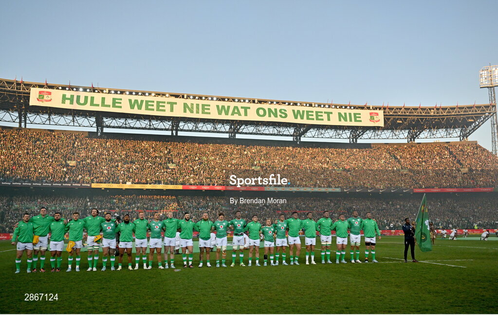 6 July 2024; The Ireland team stand for the national anthems, as a sign on at the top of the stands reads 'they don;t know what we know', before the first test between South Africa and Ireland at Loftus Versfeld Stadium in Pretoria, South Africa. Photo by Brendan Moran/Sportsfile