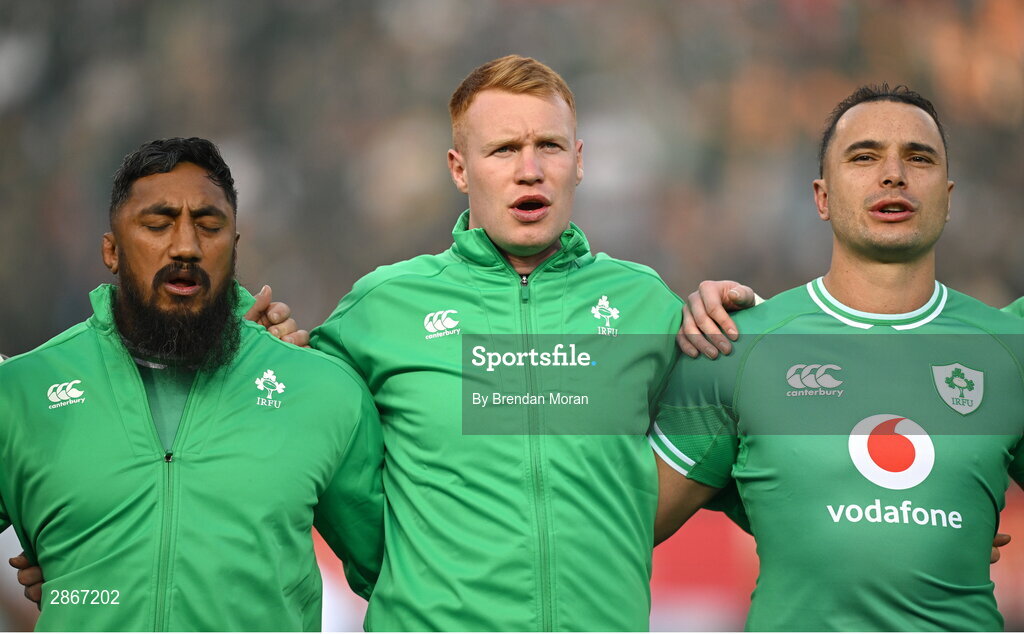 6 July 2024; Ireland players, from left, Bundee Aki, Ciarán Frawley and James Lowe during the national anthems before the first test between South Africa and Ireland at Loftus Versfeld Stadium in Pretoria, South Africa. Photo by Brendan Moran/Sportsfile