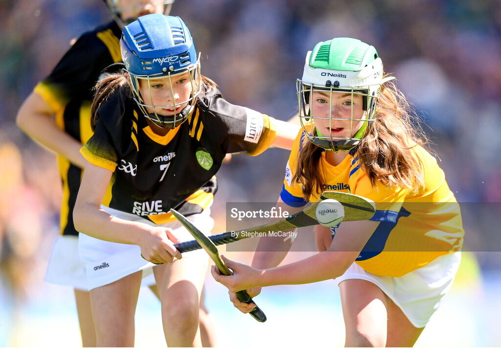 6 July 2024; Méabh Ward, St Paul's Primary School, Naval, Meath, representing Clare, in action against Eva Hamilton, Bunscoil Bóthar na Naomh, Port Láirge, representing Kilkenny, during the GAA INTO Cumann na mBunscol Respect Exhibition Go Games at the GAA Hurling All-Ireland Senior Championship semi-final match between Kilkenny and Clare at Croke Park in Dublin. Photo by Stephen McCarthy/Sportsfile