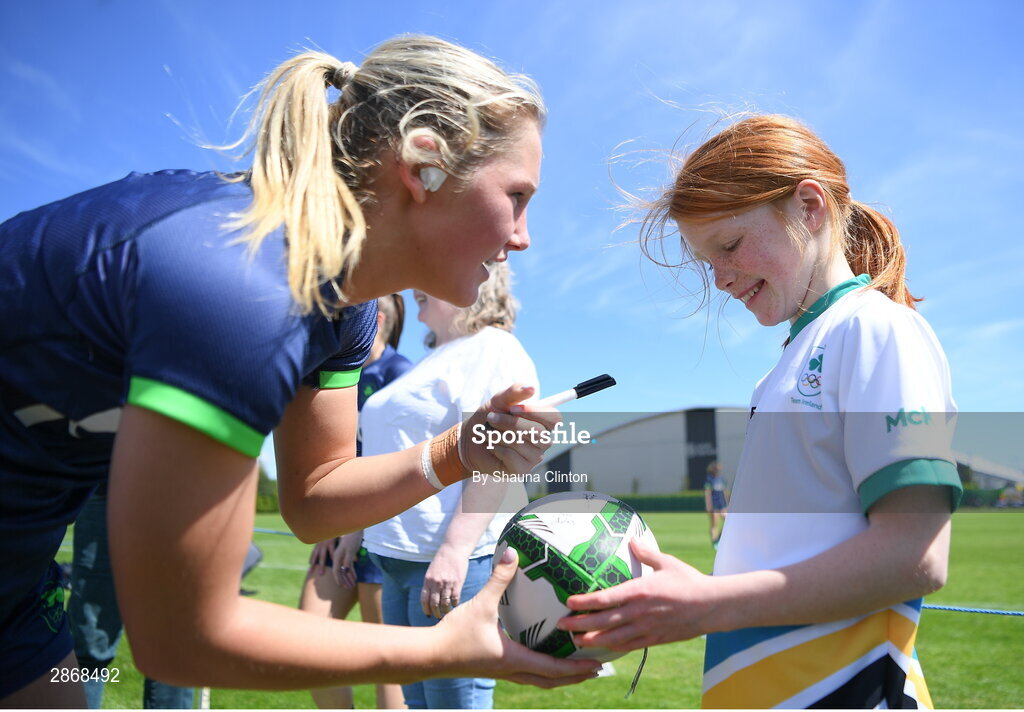 8 July 2024; Alanna Fitzpatrick signs a ball for supporter Niamh Jones during the Team Ireland Paris 2024 team training for Rugby Sevens ahead of the Paris 2024 Olympic Games at the IRFU Outdoor Pitch on the Sport Ireland Campus in Dublin. Photo by Shauna Clinton/Sportsfile