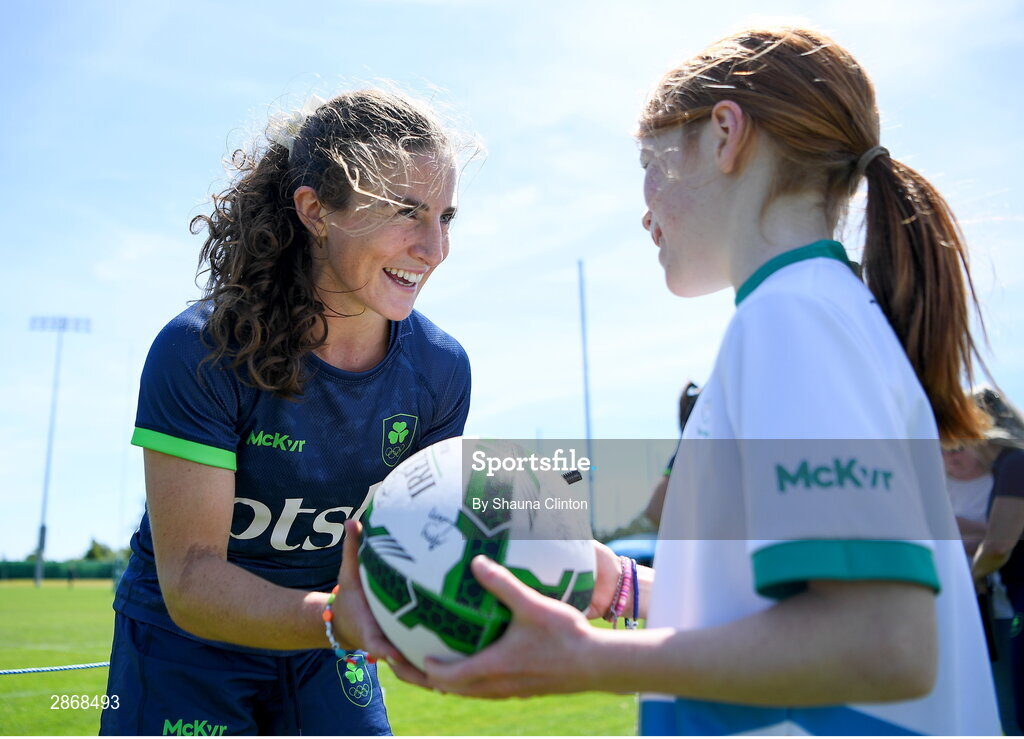 8 July 2024; Emily Lane signs a ball for supporter Niamh Jones during the Team Ireland Paris 2024 team training for Rugby Sevens ahead of the Paris 2024 Olympic Games at the IRFU Outdoor Pitch on the Sport Ireland Campus in Dublin. Photo by Shauna Clinton/Sportsfile