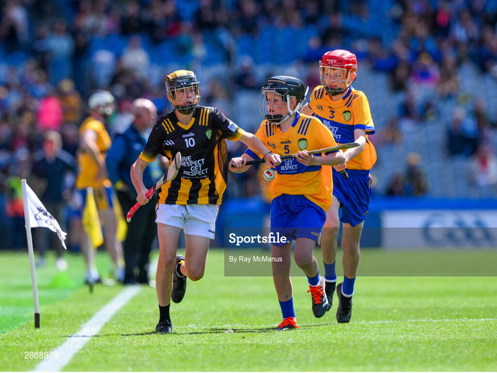6 July 2024; Mark Phelan, Scoil Mhuire, Gowran, Kilkenny, representing Kilkenny is tackled by Cillian Casey, Toreen NS, Mayo, representing Clare and John Bloomer, St Brendan's NS, Portumna, Galway, representing Clare during the GAA INTO Cumann na mBunscol Respect Exhibition Go Games at the GAA Hurling All-Ireland Senior Championship semi-final match between Kilkenny and Clare at Croke Park in Dublin. Photo by Ray McManus/Sportsfile