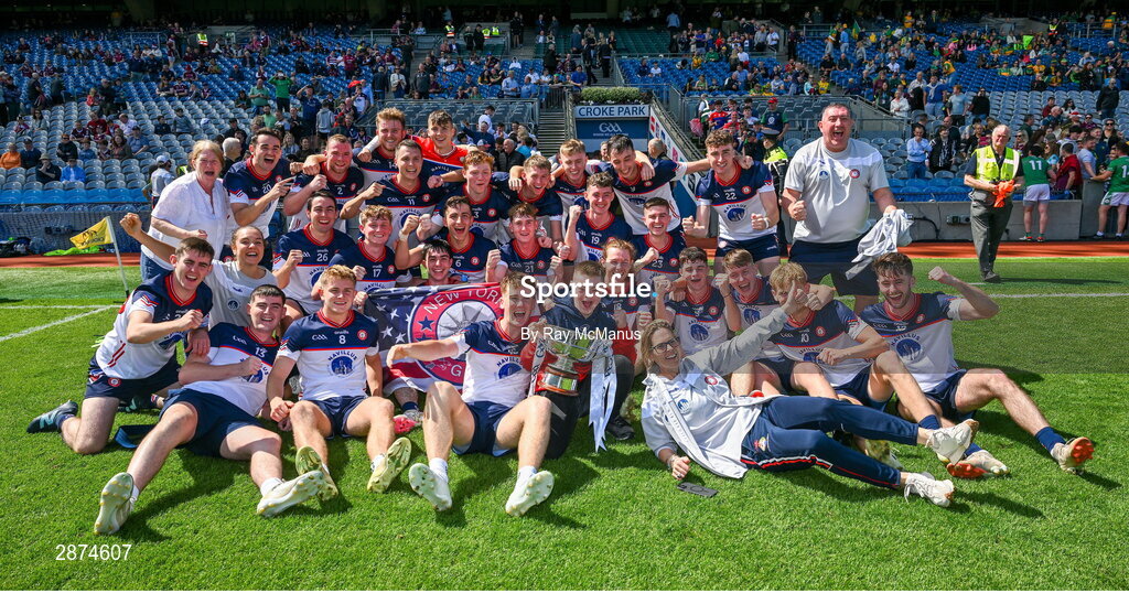 14 July 2024; Dylan Curran of New York , the NY cheerleader Pádraig Doheny and officials celebrate with the cup after the GAA Football All-Ireland Junior Championship final between London and New York at Croke Park in Dublin. Photo by Ray McManus/Sportsfile