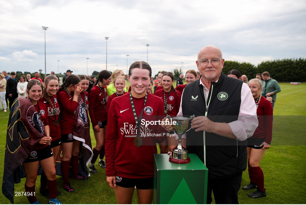 14 July 2024; Athenry captain Kerri O'Driscoll receives the cup from FAI Director of Competitions Fran Gavin after the FAI Women's Under 17 Cup final match between Athenry and Killester Donnycarney FC at Mullingar Athletic FC in Gainstown, Westmeath. Photo by Michael P Ryan/Sportsfile