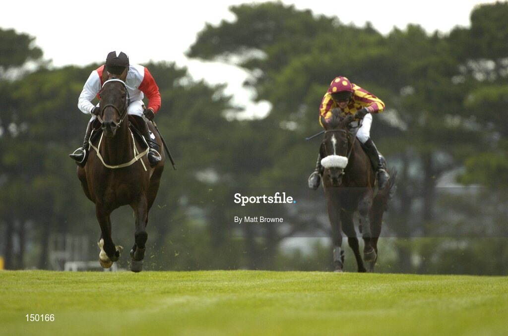 27 July 2004; Talking Cents, with Mick Fitzgerald up, on the way to winning the Albatros Plant Nutrition Steeplechase, from Ross Moff with Ruby Walsh up. Galway Races, Ballybrit, Co. Galway. Picture credit; Matt Browne / SPORTSFILE
