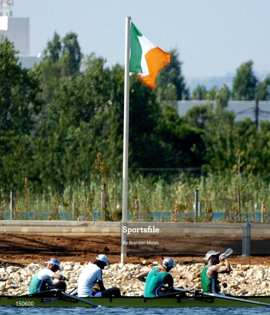 12 August 2004; Ireland's lightweight coxless fours team of, from left, Richard Archibald, Eugene Coakley, Niall O'Toole and Paul Griffin take a break in front of the Irish tricolour after an open training at the Schinias Olympic Rowing Centre. Games of the XXVII Olympiad, Athens Summer Olympics Games 2004, Athens, Greece. Picture credit; Brendan Moran / SPORTSFILE
