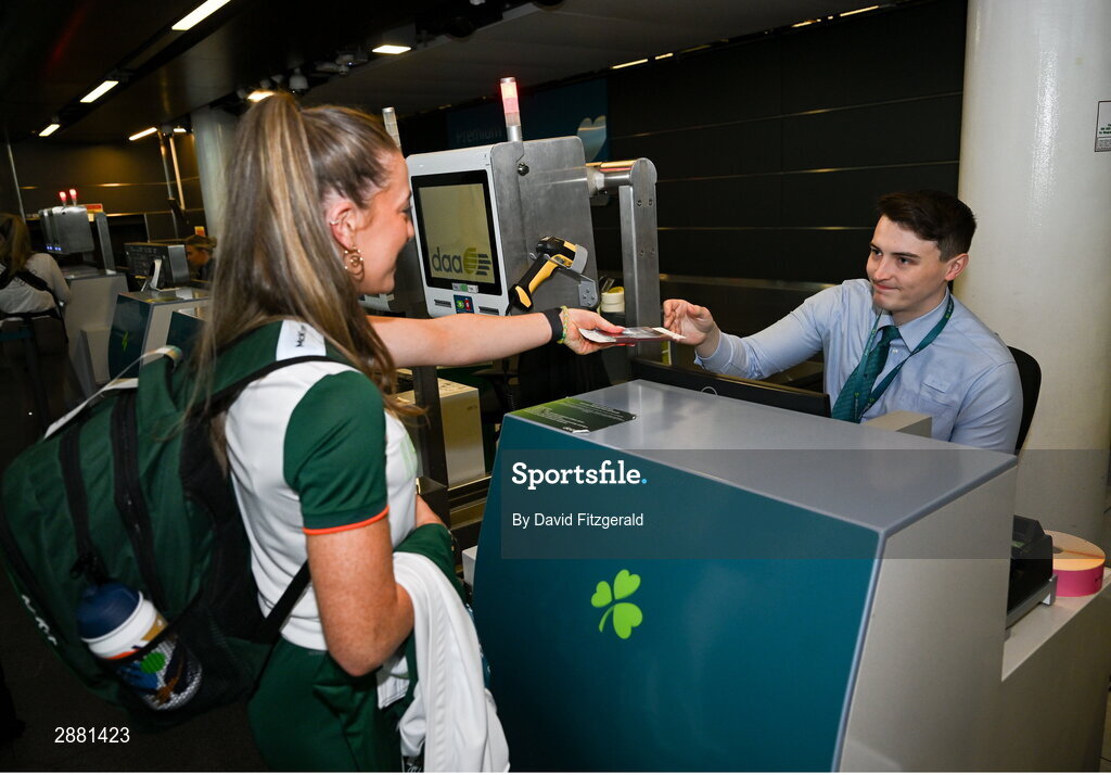 19 July 2024; Athlete Lauren Cadden receives her boarding pass from Andrew O'Riley of Aer Lingus at Dublin Airport as members of Team Ireland Depart for the 2024 Paris Olympic Games. Photo by David Fitzgerald/Sportsfile