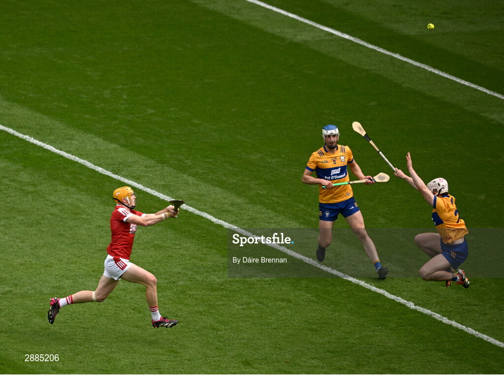 21 July 2024; Shane Barrett of Cork scores a point despite the efforts of Adam Hogan of Clare during the GAA Hurling All-Ireland Senior Championship Final between Clare and Cork at Croke Park in Dublin. Photo by Daire Brennan/Sportsfile