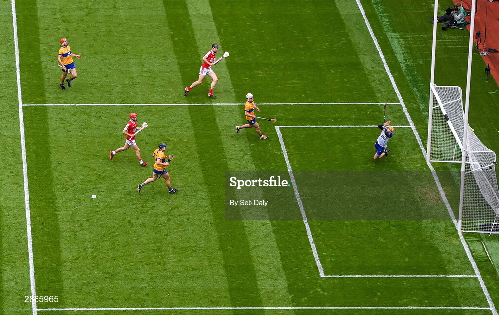 21 July 2024; Robert Downey of Cork, top, scores his side's first goal, past Clare goalkeeper Eibhear Quilligan, during the GAA Hurling All-Ireland Senior Championship Final match between Clare and Cork at Croke Park in Dublin. Photo by Seb Daly/Sportsfile