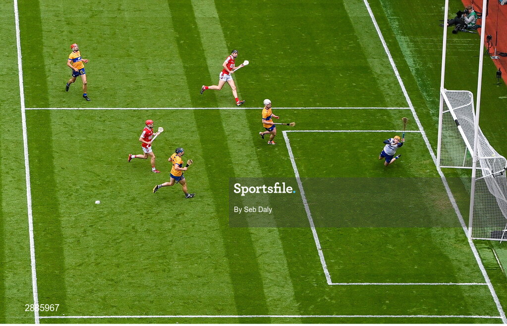 21 July 2024; Robert Downey of Cork, top, scores his side's first goal, past Clare goalkeeper Eibhear Quilligan, during the GAA Hurling All-Ireland Senior Championship Final match between Clare and Cork at Croke Park in Dublin. Photo by Seb Daly/Sportsfile