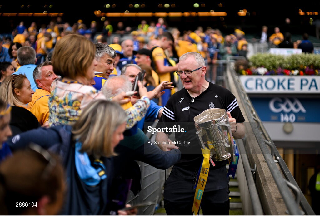21 July 2024; Clare manager Brian Lohan holding the Liam MacCarthy cup celebrates with supporters after the GAA Hurling All-Ireland Senior Championship Final between Clare and Cork at Croke Park in Dublin. Photo by Stephen McCarthy/Sportsfile