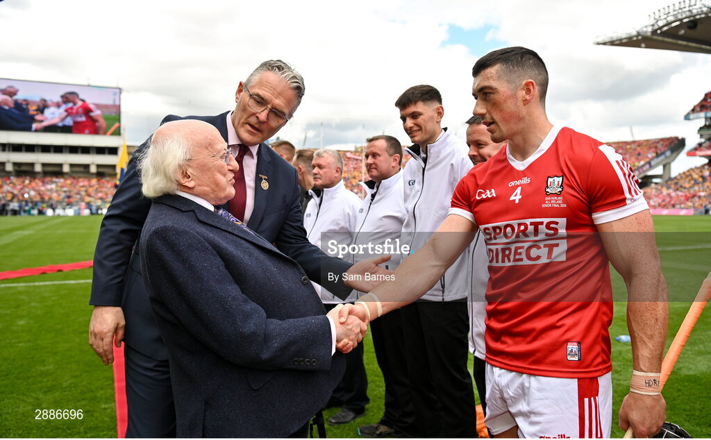 21 July 2024; President of Ireland Michael D Higgins shakes hands with Seán O'Donoghue of Cork alongside Uachtarán Chumann Lúthchleas Gael Jarlath Burns before the GAA Hurling All-Ireland Senior Championship Final between Clare and Cork at Croke Park in Dublin. Photo by Sam Barnes/Sportsfile